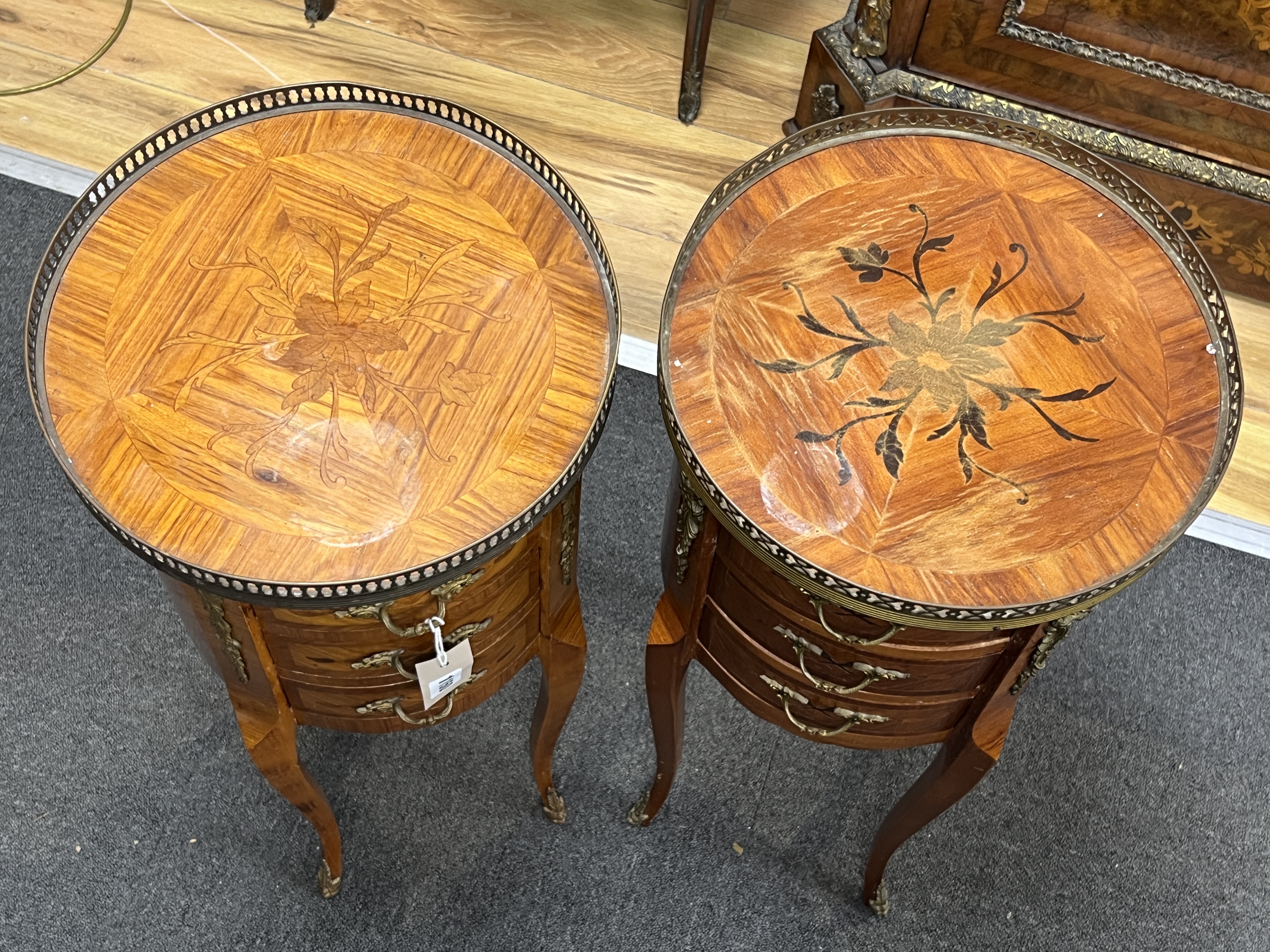 A pair of marquetry inlaid circular kingwood bedside chests, diameter 32cm, height 73cm